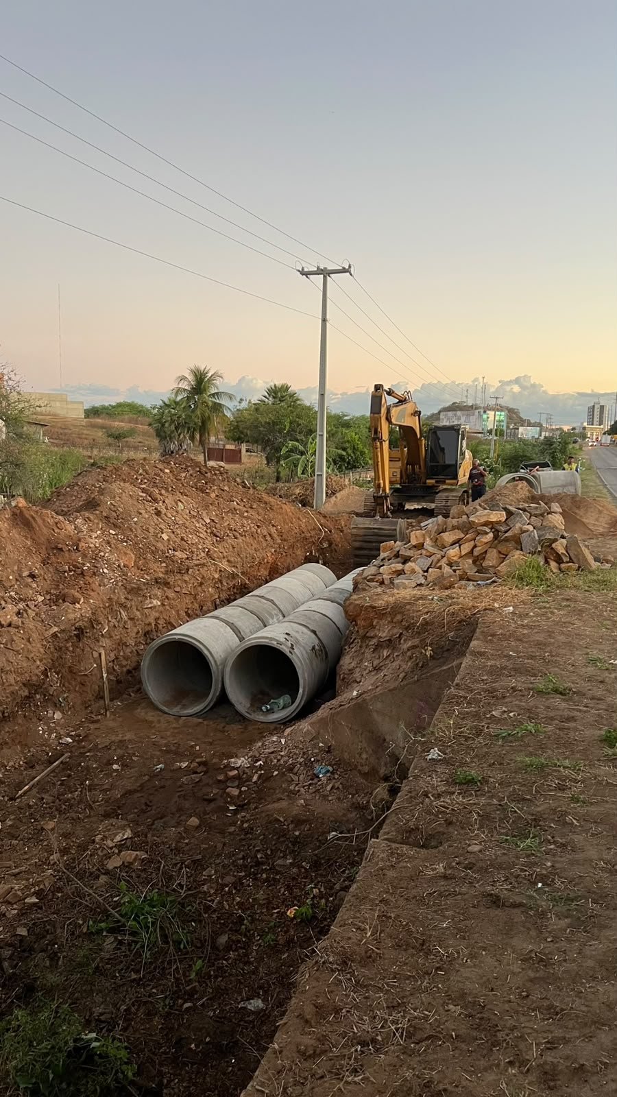Assentamento de tubos de concreto na vala de drenagem